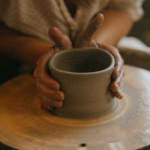 close up photo of a person molding clay